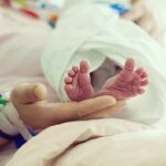 Newborn baby in hospital with identification bracelet tag name